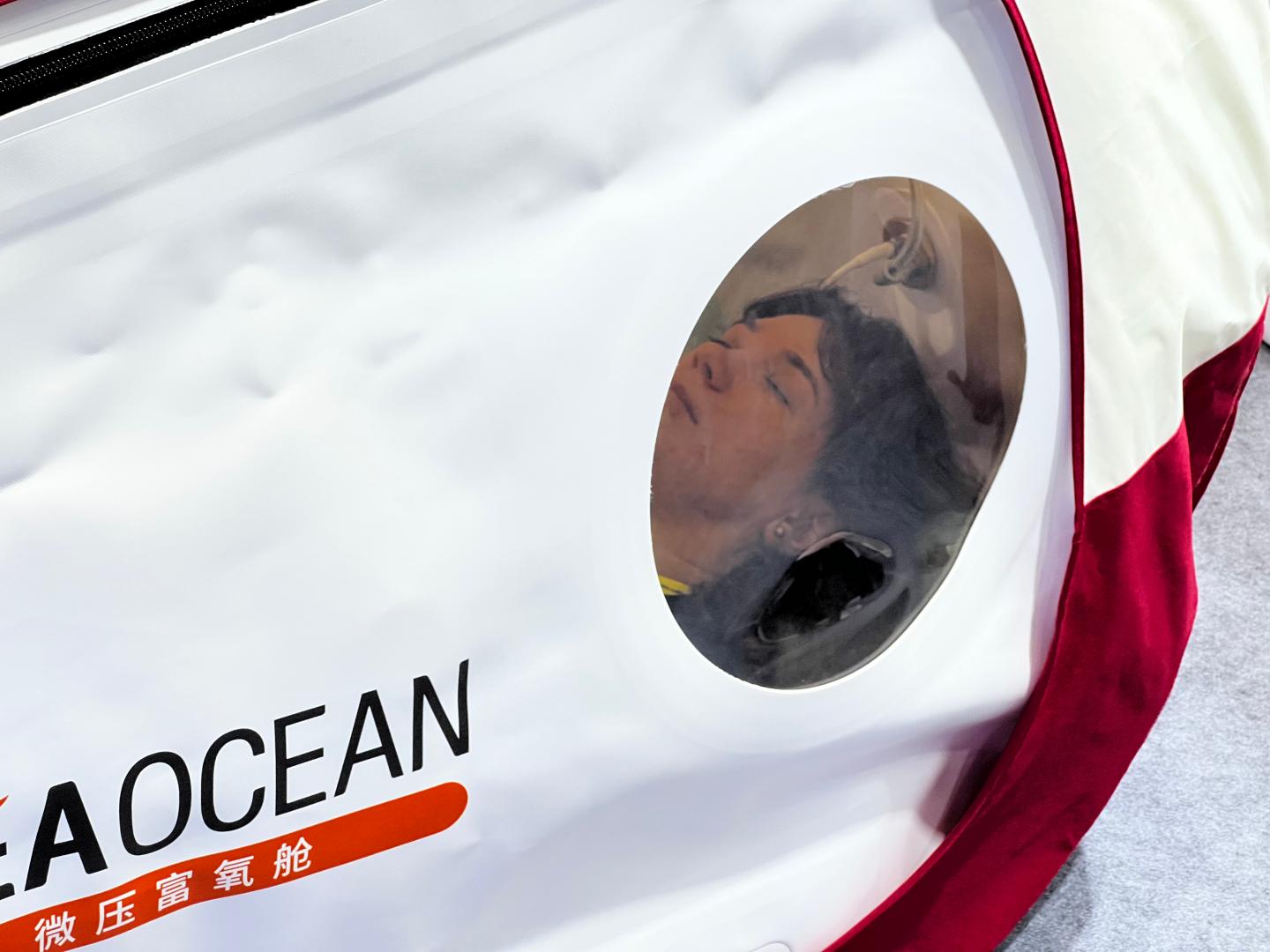 A visitor lying inside a HEAOCEAN chamber at CIFIT 2026